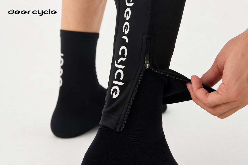 A rider opening the ankle zipper on a DEER leg warmer.