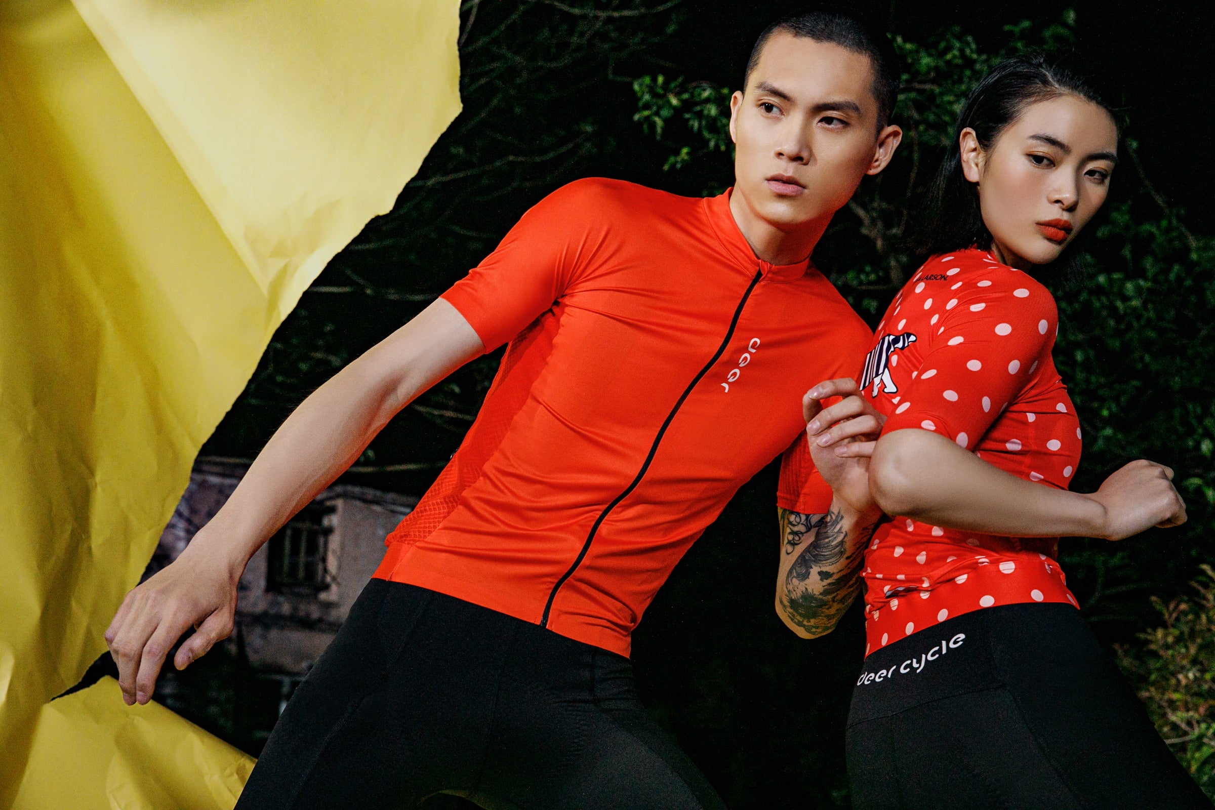 Male cyclist wearing a red DEER cycling jersey in a mixed-rider campaign image.