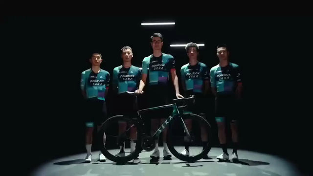 Cycling team standing with a road bike