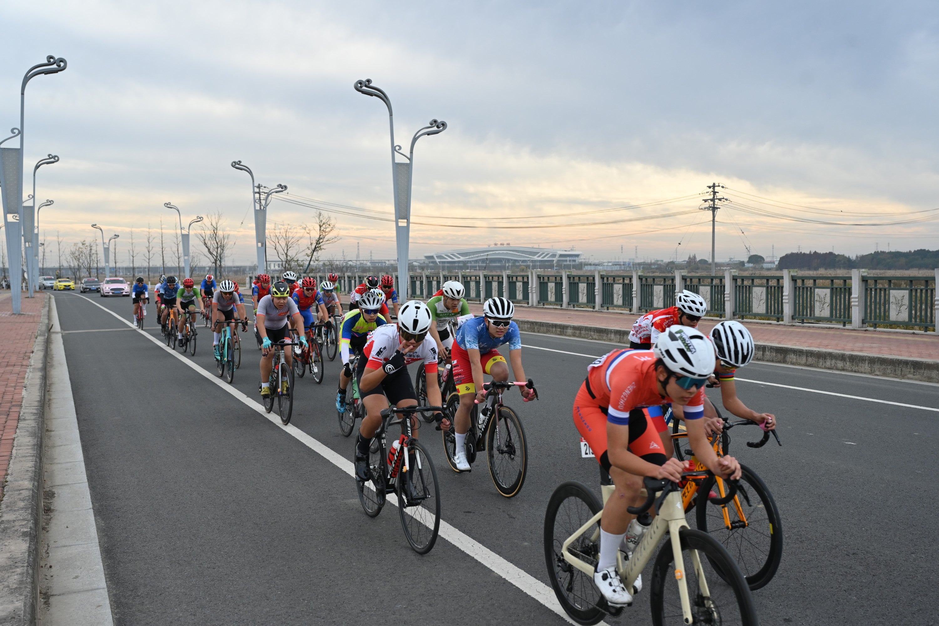 A group of cyclists riding together on a road.
